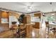 Spacious kitchen with hardwood floors, ceiling fan, wooden cabinets, island, and breakfast nook at 10036 E Troy Ave, Indianapolis, IN 46239