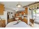 Open kitchen and dining area with hardwood floors, ceiling fan, and view to the backyard at 10036 E Troy Ave, Indianapolis, IN 46239