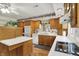 Bright kitchen with wood cabinets, white countertops, stainless steel appliances, and breakfast bar at 10036 E Troy Ave, Indianapolis, IN 46239