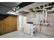 Basement laundry area with updated appliances and ample storage at 10036 E Troy Ave, Indianapolis, IN 46239