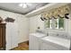 Bright laundry room featuring updated washer and dryer, with plenty of storage at 10036 E Troy Ave, Indianapolis, IN 46239