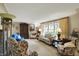 Bright living room area with a large window and neutral carpet at 10036 E Troy Ave, Indianapolis, IN 46239