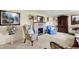 Cozy living room with a stone fireplace, decorative furniture, and unique artwork enhancing its inviting atmosphere at 10036 E Troy Ave, Indianapolis, IN 46239