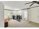 Cozy living room featuring staircase, plush carpet, and neutral color palette at 10036 E Troy Ave, Indianapolis, IN 46239
