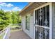 View of porch with secure entry door and decorative white steel guard at 10036 E Troy Ave, Indianapolis, IN 46239