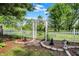 Lush yard with landscaped garden beds featuring a decorative arbor and picket fence at 10036 E Troy Ave, Indianapolis, IN 46239