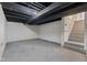 An unfinished basement with concrete floors, exposed ceilings, and a stairway at 1108 N Ritter Ave, Indianapolis, IN 46219