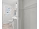 Clean bathroom with a modern vanity, toilet, and wire shelving for simple storage at 1108 N Ritter Ave, Indianapolis, IN 46219