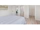 Bedroom features hardwood floors, view to bathroom and walk-in closet at 1108 N Ritter Ave, Indianapolis, IN 46219