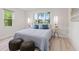 Bright bedroom with large windows, wood floors, stylish lamps and decorative pillows at 1108 N Ritter Ave, Indianapolis, IN 46219