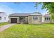 Lovely one-story home with stone accents, attached garage, and well-maintained front yard at 1108 N Ritter Ave, Indianapolis, IN 46219