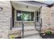 Inviting front porch with stone details and decorative railing welcomes you home at 1108 N Ritter Ave, Indianapolis, IN 46219