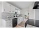 Bright kitchen with white cabinets, granite countertops, and modern appliances at 1108 N Ritter Ave, Indianapolis, IN 46219