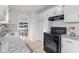 Modern kitchen with white cabinets, granite countertops, and stainless steel appliances at 1108 N Ritter Ave, Indianapolis, IN 46219