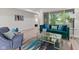 Well-lit living room with modern furniture, a glass coffee table, and view to the bedroom at 1108 N Ritter Ave, Indianapolis, IN 46219