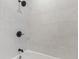 Modern tiled shower showcasing large marble-like tiles with sleek, dark hardware and fixtures at 1108 N Ritter Ave, Indianapolis, IN 46219