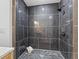 Modern walk-in shower features dark tiled walls and floors at 1108 N Ritter Ave, Indianapolis, IN 46219