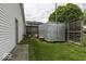 A backyard view shows the side of the house and a large trailer for storage at 1190 W Jefferson St, Franklin, IN 46131