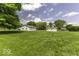 Expansive backyard featuring well-kept lawn and multiple outbuildings at 1190 W Jefferson St, Franklin, IN 46131