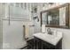 Charming bathroom with a black vanity and a decorative mirror above the sink at 1190 W Jefferson St, Franklin, IN 46131