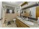 Well-lit bathroom featuring a double sink vanity with granite countertop and tiled walls at 1190 W Jefferson St, Franklin, IN 46131