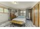 Well-lit bedroom with a patterned bedspread, rustic wooden table, and ample closet space at 1190 W Jefferson St, Franklin, IN 46131