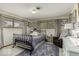Bright bedroom with a metal frame bed, large windows, and a comfortable armchair at 1190 W Jefferson St, Franklin, IN 46131
