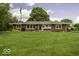Charming single-story brick home with a large front yard and American flag at 1190 W Jefferson St, Franklin, IN 46131