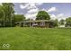 A well-maintained ranch-style home with a tidy lawn and mature trees at 1190 W Jefferson St, Franklin, IN 46131