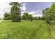 A view of the long lawn and tree-lined property at 1190 W Jefferson St, Franklin, IN 46131
