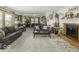 Spacious living room with a brick fireplace, neutral carpet, and multiple seating areas at 1190 W Jefferson St, Franklin, IN 46131