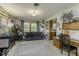 Inviting living room featuring a plush sofa, a large window, and a functional desk space at 1190 W Jefferson St, Franklin, IN 46131