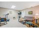 Carpeted basement with tv, futon, seating, lighting, and a treadmill area at 12082 Old Stone Dr, Indianapolis, IN 46236