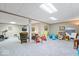 Wide open basement featuring a rec area, with toys, and a tv viewing section, and a treadmill at 12082 Old Stone Dr, Indianapolis, IN 46236