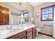 Bathroom featuring a double sink vanity with countertop space, and well-lit with natural light at 12082 Old Stone Dr, Indianapolis, IN 46236