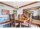 Formal dining room with wood floors, large table and chairs, and elegant chandelier at 12082 Old Stone Dr, Indianapolis, IN 46236