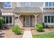 Close up of the front entrance of an elegant two story home with brick exterior and covered front porch at 12082 Old Stone Dr, Indianapolis, IN 46236