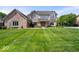 Beautifully landscaped home featuring a well-manicured lawn, and charming exterior at 12082 Old Stone Dr, Indianapolis, IN 46236