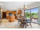 Well-lit eat-in kitchen with stainless appliances and adjacent dining area leading to outdoor patio at 12082 Old Stone Dr, Indianapolis, IN 46236