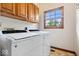Laundry room with large capacity washer and dryer and natural light streaming from the window at 12082 Old Stone Dr, Indianapolis, IN 46236