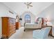 Main bedroom with vaulted ceiling, plush carpeting, and a large arched window at 12082 Old Stone Dr, Indianapolis, IN 46236