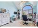 Bright office with vaulted ceilings, an arched window, a ceiling fan and built-in shelving at 12082 Old Stone Dr, Indianapolis, IN 46236