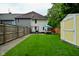 This backyard features a well-kept lawn, a shed, an outdoor dining and patio furniture set, and a grill at 1236 Central Ave, Indianapolis, IN 46202