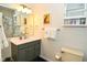 This bathroom features a single sink with cabinet, a mirrored medicine cabinet, and a shower with floral curtains at 1236 Central Ave, Indianapolis, IN 46202