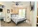 This bedroom features a ceiling fan, a double-hung window with curtains, and a comfortable queen bed at 1236 Central Ave, Indianapolis, IN 46202
