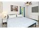 Bright bedroom with a ceiling fan, neutral walls, and a comfortable bed with blue bedding at 1236 Central Ave, Indianapolis, IN 46202