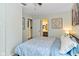 Cozy bedroom features comfortable bedding, and doorway view to bathroom at 1236 Central Ave, Indianapolis, IN 46202