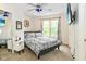 Sunlit bedroom with large window, stylish furnishings, and a ceiling fan for added comfort at 1236 Central Ave, Indianapolis, IN 46202