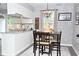 Bright dining area adjacent to kitchen featuring modern lighting and neutral tones at 1236 Central Ave, Indianapolis, IN 46202