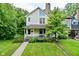 Charming two-story home with a front porch and well-maintained lawn at 1236 Central Ave, Indianapolis, IN 46202